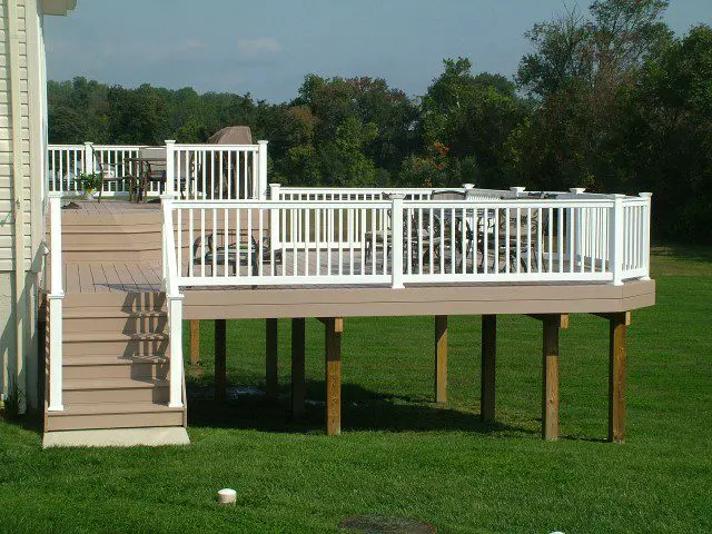 A wooden deck featuring a railing and stairs, providing access to the ground level and enhancing outdoor space.